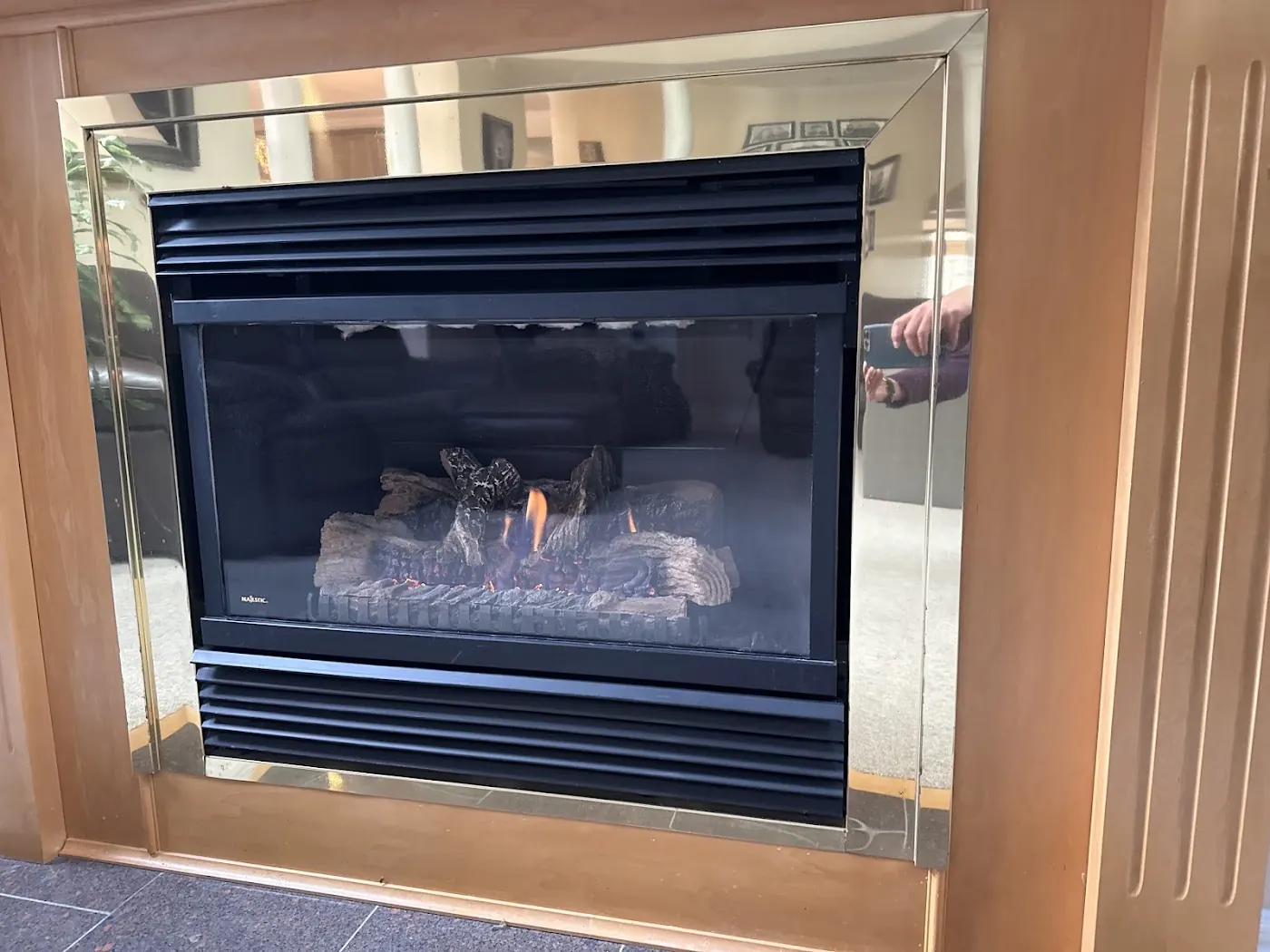 Majestic gas fireplace with gold frame and visible flame