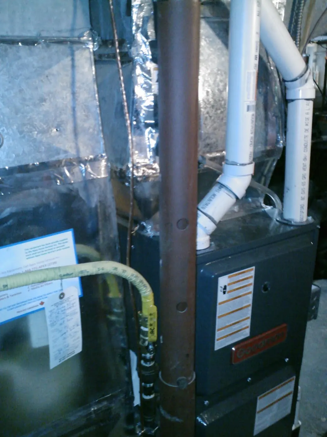 Goodman furnace installed in a basement with ductwork and gas line